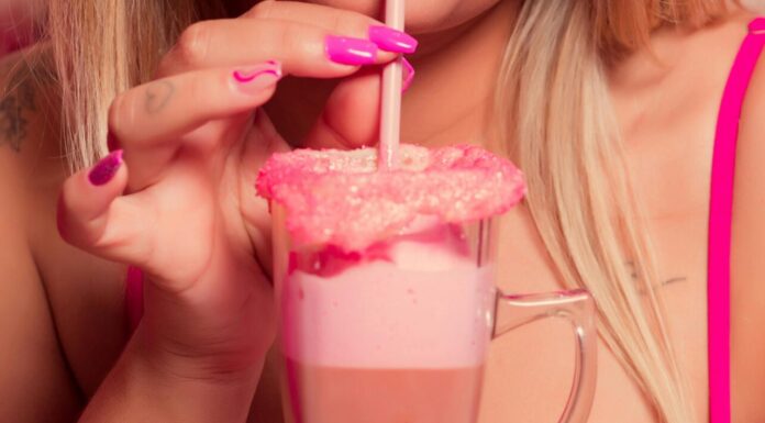 Enjoy Your Summer With the Shirley Temple Float Closeup of a Woman Wearing Pink Makeup, Drinking a Milkshake with a Straw